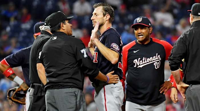 Jun 22, 2021; Philadelphia, Pennsylvania, USA; Washington Nationals pitcher Max Scherzer (31) and manager Dave Martinez (4) talk with umpire Alfonso Marquez (72) as they check for a foreign substance on Scherzer during the middle of the fourth inning against the Philadelphia Phillies at Citizens Bank Park.
